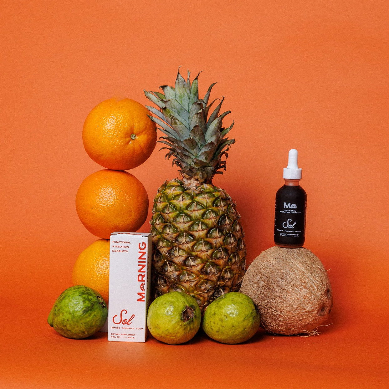 Fruits and a bottle on an orange background
