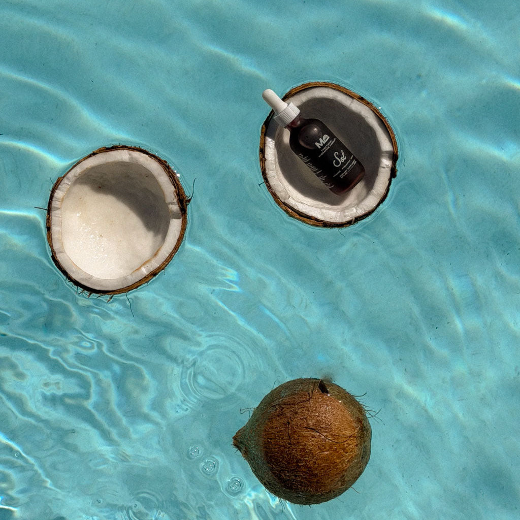 Coconuts floating in clear blue water